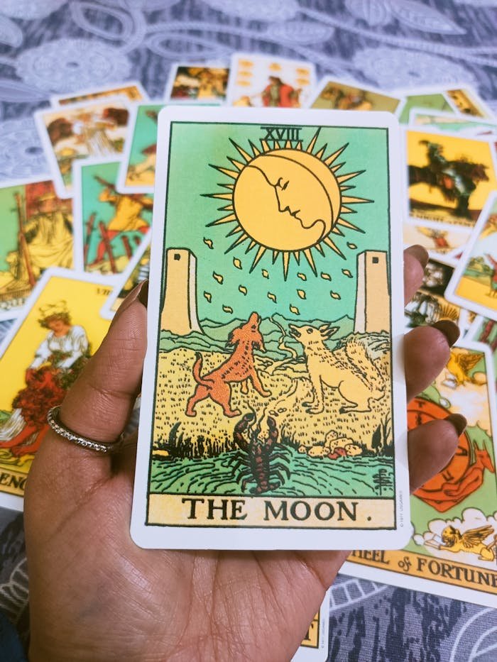 about-us A close-up of The Moon tarot card held in hand, ideal for spiritual themes.